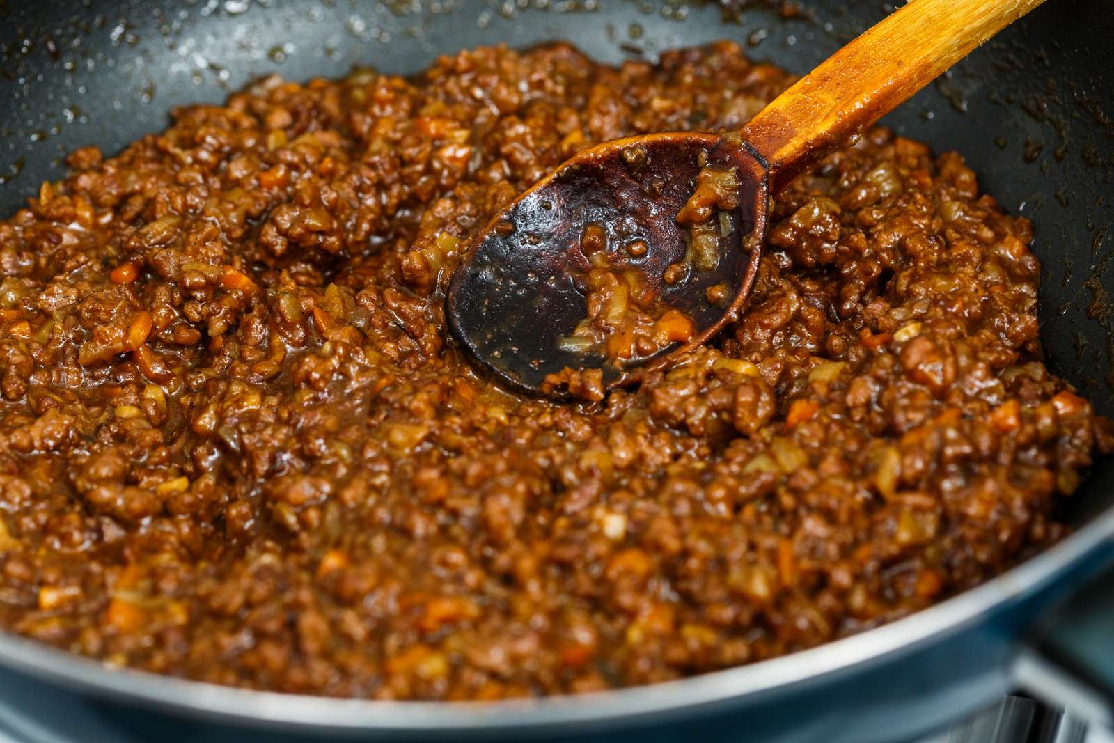 Minced beef with sauce in the frying pan, cottage pie recipe
